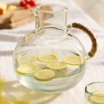 Cane Handle Glass Carafe – Hand-Crafted Round Glass Pitcher with Natural Woven Handle